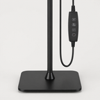 Close-up of the square metal lamp base and lower pole