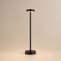 Black Ovnus HaloStem cordless table lamp illuminated on a clean light background