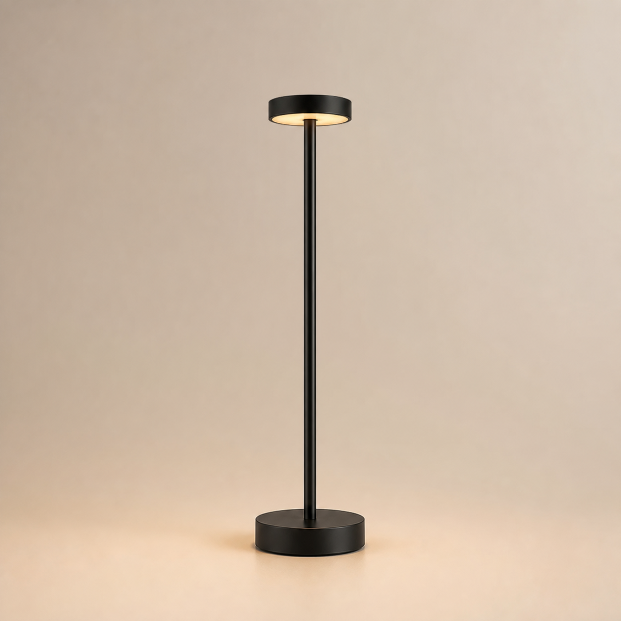 Black Ovnus HaloStem cordless table lamp illuminated on a clean light background